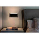 LED Wandleuchte MOOD 2x3W Braun, Schwarz an einer Wand neben einem Bett und Nachttisch.