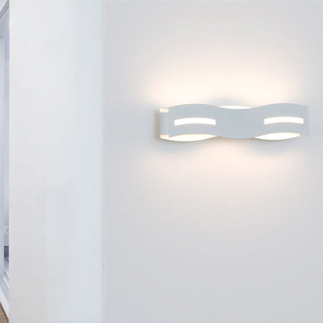 LED Wandleuchte Wave Weiß an einer Wand mit warmweißem Licht.