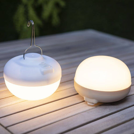 Cherry table and pendant light with solar panel, portable light on a table, ideal for outdoor events.
