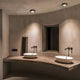 Modernes Badezimmer mit Santa-Flat Deckenaufbauspot und eleganten Waschbecken.