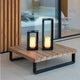 Siroco LED table & outdoor floor lamp flame effect on a wooden table, elegant and stylish in a modern room.