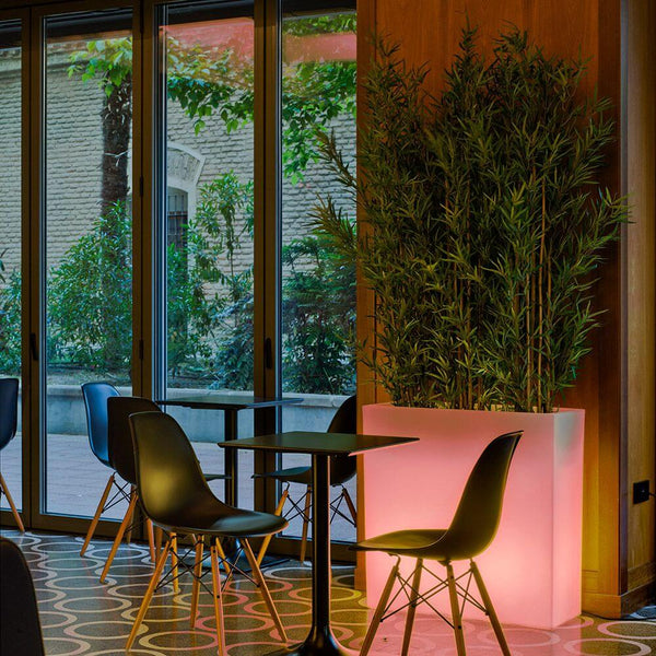 Square flower pot Junco with battery and remote control, stylish planter in a modern room setting.