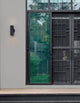 Limbio Außenwandleuchte H 18cm GU10 Up & Down IP54 an einer modernen Hauswand mit Glas und Holzterrasse.