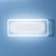 Antille LED-Wandleuchte Small an einer blauen Wand, modernes und elegantes Design für zeitgemäße Beleuchtung.