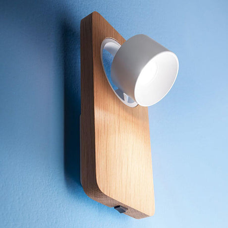 Beebo W LED wall light on a blue wall, modern design with wooden and white light elements.