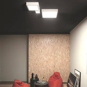 Modern Box SQ LED ceiling light Medium in a stylish room with red bean bags.