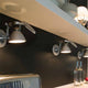Luceplan Fortebraccio Wand- & Deckenstrahler Ø 11cm an einer Wand mit modernen, stilvollen Lampen.