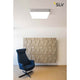 Medo 60 Square LED Deckenleuchte Silbergrau 1-10V 3000K an der Decke über einem stilvollen blauen Sessel.