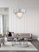 Magnolia Pendelleuchte Prismatisch 6-flammig Ø 50cm im eleganten Wohnzimmer mit modernem Interieur.