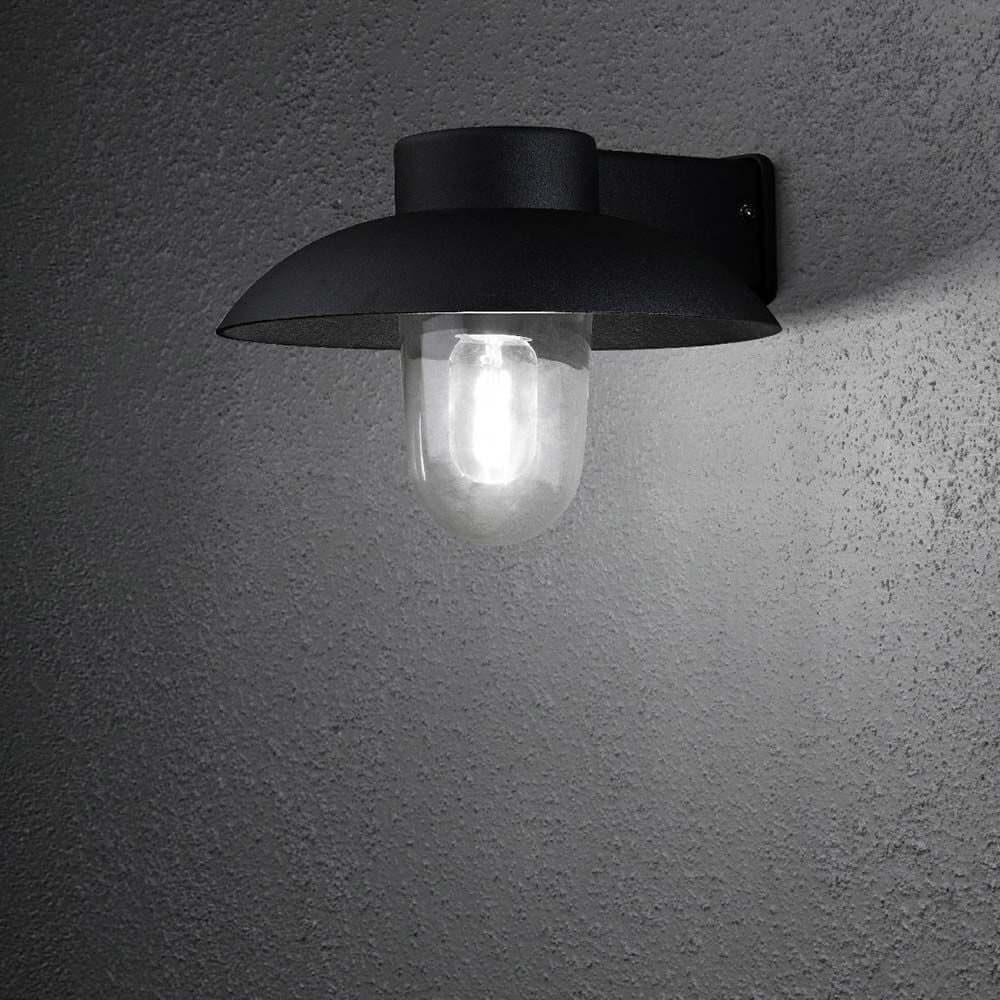 Mani Außen-Wandleuchte Schwarz, klares Glas an einer Wand montiert, modernes Design mit klarer Glasabdeckung.