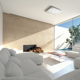 Moderne Wohnlandschaft mit eckiger Crystal LED Mirror Deckenleuchte und stylishen Möbeln im hellen Raum.