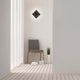 Moderne Dakla LED-Wandlampe klein in eckiger Form, installiert in stilvollem Raum mit Holzfußboden und Stuhl.