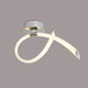 Moderne LED-Wandleuchte Schleife Armonia aus Metall und Kunststoff in geschwungener Form.