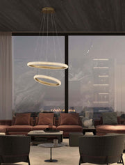 Medora LED pendant light 2-bulb Ø 59cm 3000K brass gold in a modern living room above the dining table.