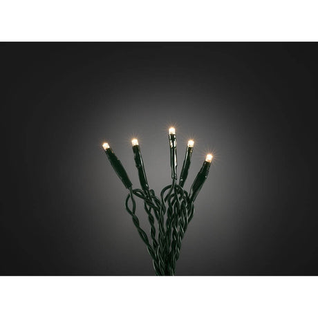 4m Micro LED light chain with 10 warm white diodes shines in festive light against a dark background.