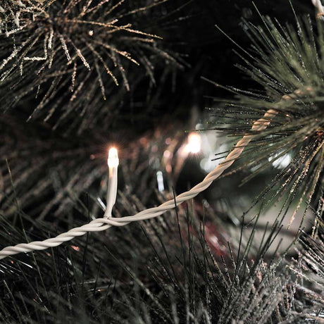 Micro LED string lights 40 warm white diodes IP44 on a Christmas tree, illuminated and festively decorated.