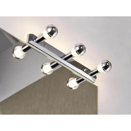 Mirror Regula light strip max. 3x40W E14 chrome mounted above a mirror.