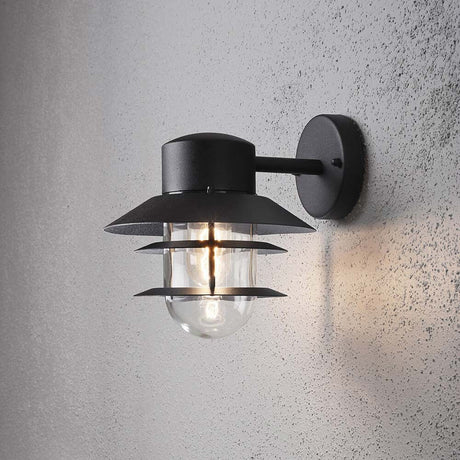 Modena Außen-Wandleuchte Schwarz, klares Glas an einer Wand montiert mit elegantem Design.