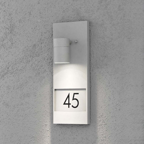 Modena zewnętrzna lampa ścienna z numerami domu Szary przezroczyste szkło, reflektor na ścianie z numerem 45.