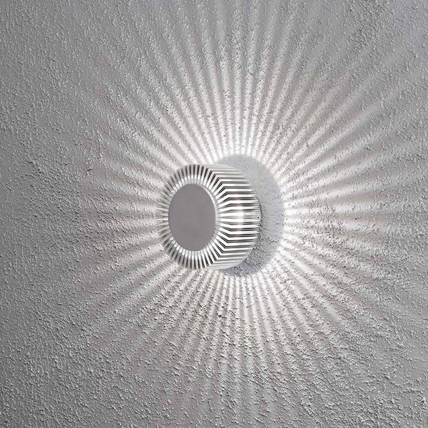 Monza LED effect outdoor wall light, solid aluminium on a wall with light effects.