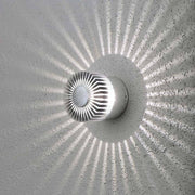 Monza LED effect outdoor wall light with a unique lighting design and stylish shadow effects on the wall.