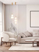 Moderne Wohnatmosphäre mit Movil Pendelleuchte 3-flammig Ø 17cm 3000K Gold über elegantem Sofa.