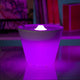 Rotaliana Multipot+ table lamp cable container + charging station white in purple illuminated design on table.