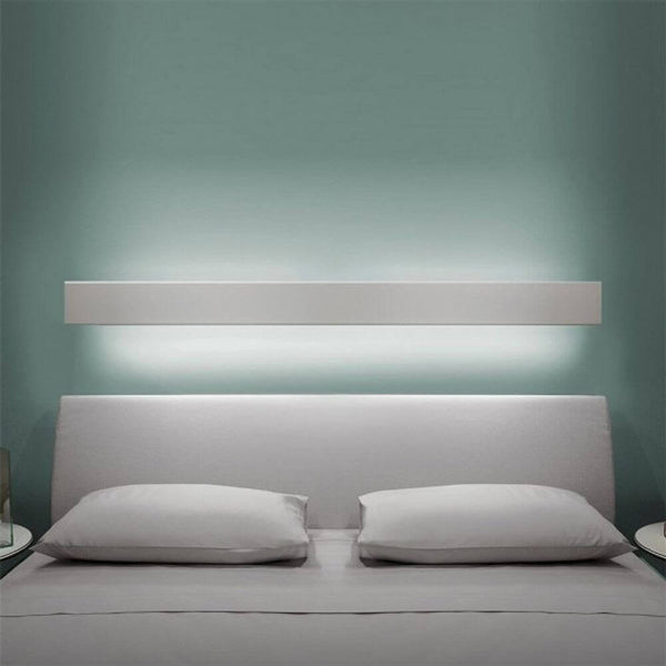 Nemo Angolo LED corner light 200cm above a bed, softly illuminated, modern wall mounting, dimmable, indirect light