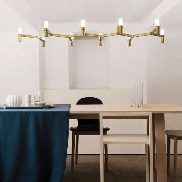 Nemo Crown Plana Linea dining table lamp 10-light 168 cm above a modern dining table in a stylish room.