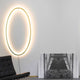 Nemo Ellisse Wandbefestigung gold als Wandleuchte in modernem Interieur mit ovalem Design.