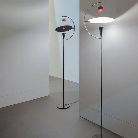 Nemo Newton LED floor lamp with foot dimmer in a modern setting with a chrome-plated and black structure.
