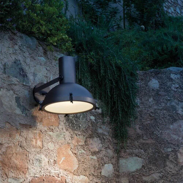Nemo Projecteur 365 outdoor wall spotlight IP65 illuminated on a stone wall at night.