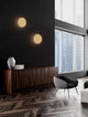 Nevo LED Wandleuchte Ø 30cm 3000K an einer modernen Wand mit dunklem Hintergrund.