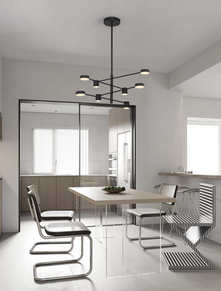 Nordik LED Pendelleuchte 8-flammig Ø 100cm 3000K Schwarz über einem modernen Esstisch in einem hellen Raum.