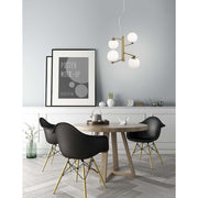 Agrigento 4-light pendant lamp brass, white above a round dining table in a modern interior.