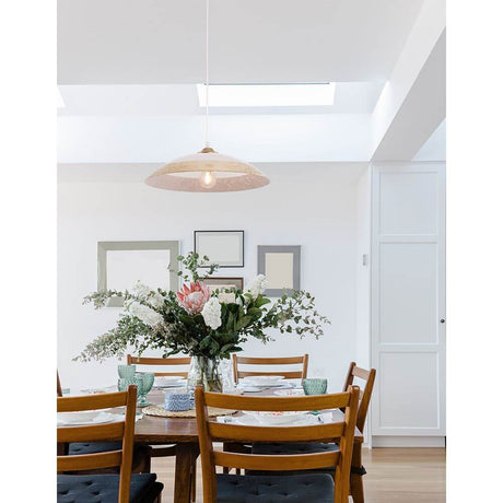 Benito Hängelampe aus Glas über dem Esstisch mit Blumenarrangement und moderne Einrichtung.