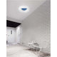 Cia LED Deckenlampe Acryl in modernem Raum mit weißer Ziegelwand und Designerstuhl.