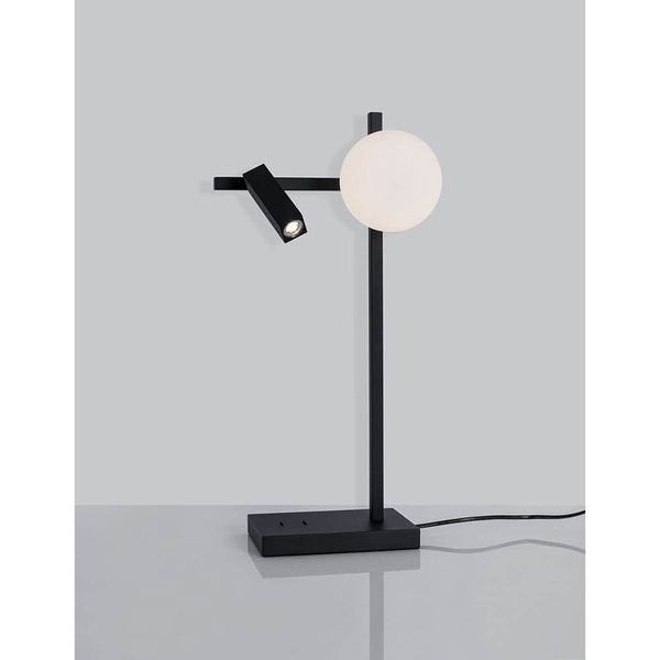 Lampe de table Joline LED noire sur une table, au design moderne, avec une source lumineuse ronde et une source lumineuse orientable.