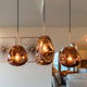 Lava Hängeleuchte mundgeblasenes Glas in Kupferfarbe, moderne Pendelleuchte im Wohnzimmer.