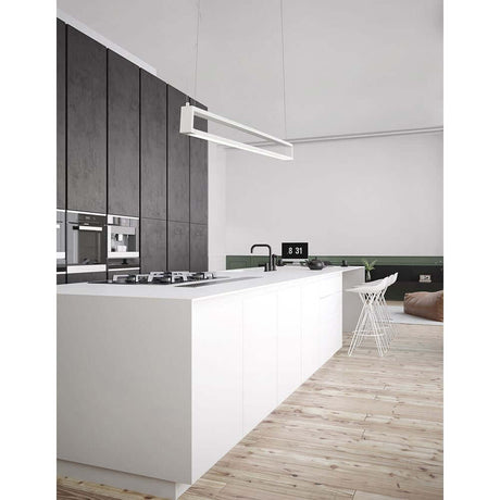 Modern kitchen with Line LED pendant light 130cm above the white kitchen island and wooden floor.