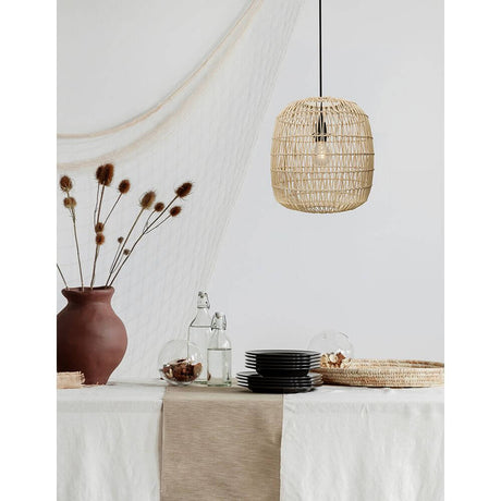 Melody rattan pendant light in wood colour above a set table with decorations.
