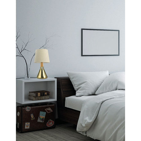 Montes metal table lamp with fabric shade on a bedside table in a modern bedroom.