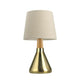 Montes Metall Tischlampe mit Textilschirm aus goldfarbenem Metall und beige Stoffschirm mit Holzdetail.