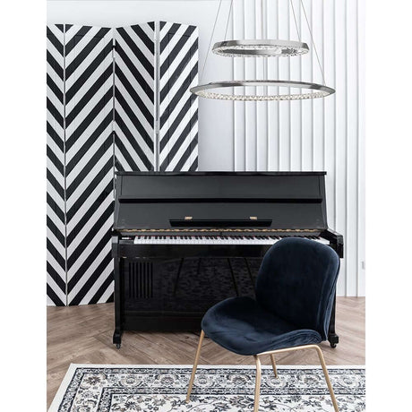 Netuno LED pendant light clear, chrome shimmering above a piano in a modern interior.