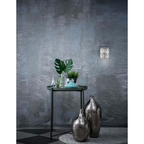 Beautiful interior with Nice wall light chrome, clear on the wall and stylish vases on a table.