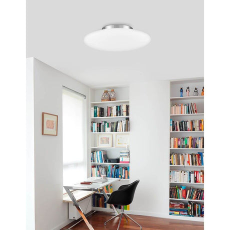 Pressione glass ceiling light Ø 50cm in a modern room with bookshelves and desk.