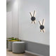 Zwei Reslin LED Metall Wandleuchten in modernem Design an einer Wand, die warmweißes Licht spenden.