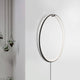 Ring LED-Wandleuchte zum aufhängen Schwarz an einer Wand mit hängenden Pflanzen daneben.