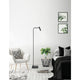 Nova Luce Sicily LED adjustable floor lamp in black with curved arm in a modern bedroom