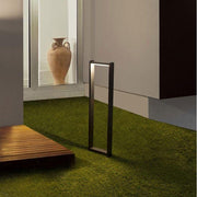 Volver LED bollard light rotatable black on lawn in a modern outdoor area.
